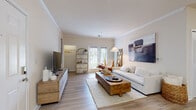 Located at 9015 Kings Grant Dr in Charlotte, NC, this single-floor residence offers a thoughtfully designed layout with a cohesive, contemporary aesthetic throughout. The living room is a welcoming focal point, featuring crown molding, light wood-style flooring, and neutral walls that create a bright, airy atmosphere. French doors allow natural light to flow in and offer views to the outdoors, enhancing the open feel of the space.

The kitchen is well-equipped and functional, showcasing crisp white shaker cabinetry, granite countertops, a classic subway tile backsplash, and black appliances including a range, microwave, and refrigerator. A peninsula with seating provides an ideal spot for casual dining or entertaining.

The primary bedroom offers a serene retreat with plush carpeting, a decorative accent wall, a ceiling fan, and a window dressed with sheer curtains that invite soft, diffused light. A second bedroom continues the calm, neutral palette with its own accent wall and cozy feel.

Both bathrooms are finished with wood-style flooring, white vanity cabinetry, and a tub-shower combination, offering clean and practical design. Throughout the residence, the consistent use of warm neutrals, natural textures, and quality finishes creates a cohesive and inviting living environment.