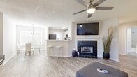 Located in Murfreesboro, TN, this well-appointed 1-bedroom, 1-bathroom home offers a thoughtfully designed open-concept layout that maximizes every square foot. Light-toned wood-style flooring runs throughout the main living areas, creating a clean and cohesive aesthetic.

The combined kitchen and living room serves as the heart of the home. The kitchen features white shaker-style cabinetry, quartz-style countertops, a full suite of stainless steel appliances including a refrigerator, range, microwave, and dishwasher, and a peninsula with bar seating — ideal for casual dining or entertaining. The living area is anchored by a dark tile-surround fireplace with a white mantel, adding warmth and character. A ceiling fan overhead and natural light from multiple windows complete the inviting atmosphere.

The bedroom is a comfortable retreat with plush carpeting, a ceiling fan, and direct access to a dedicated closet. The full bathroom offers a single vanity with ample storage, a mirror with lighted fixtures, and a tub-shower combination.

A dedicated laundry area accommodates a full-size washer and dryer, adding everyday convenience. The layout is efficient and functional, making this home a practical and attractive option in the Murfreesboro area.
