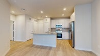 Located at 19939 Longenbaugh Rd in Houston, TX, this single-story, one-bedroom, one-bathroom residence offers a clean, modern design with thoughtful finishes throughout. Light wood-style flooring flows seamlessly across the entire unit, creating a bright and cohesive aesthetic.

The open-concept kitchen is a standout feature, equipped with stainless steel appliances including a range, over-the-range microwave, and a side-by-side refrigerator with water and ice dispenser. Crisp white cabinetry with sleek hardware extends to the ceiling, maximizing storage, while a neutral tile backsplash adds texture. A central kitchen island with a granite countertop and an undermount sink serves as both a functional workspace and a casual gathering point.

The bedroom is a comfortable, well-proportioned room featuring a ceiling fan, a window that allows in natural light, and direct access to a spacious walk-in closet outfitted with wire shelving on multiple walls for organized storage.

The bathroom features a granite-topped vanity with white cabinetry, a full tub and shower combo surrounded by elegant marble-look tile, and recessed lighting. The overall ambiance of the space is clean, bright, and move-in ready, reflecting a contemporary style suited for comfortable everyday living.