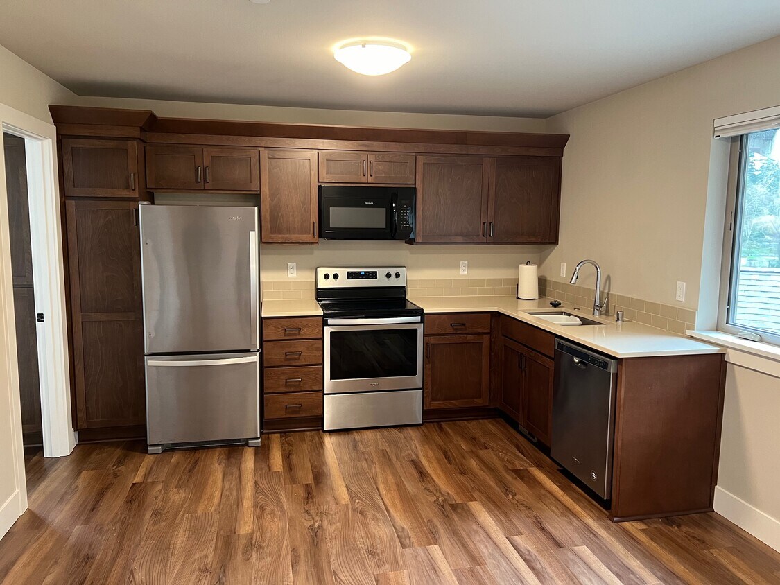 Kitchen with quartz countertops and stainless steel appliances - 6121 NE 195th Pl