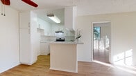 Located at 3325 Castle Heights Ave in Los Angeles, CA, this single-floor unit offers a well-designed, light-filled layout with consistent wood-style flooring throughout. The updated kitchen is a standout feature, showcasing crisp white shaker cabinetry, light granite-style countertops, a stainless steel gas range with overhead ventilation, and a peninsula that opens to the adjacent living area — ideal for everyday functionality and casual entertaining. The spacious living room is anchored by a classic brick fireplace and provides a relaxed, open atmosphere with direct sightlines to other areas of the home. The bedrooms are generously proportioned, featuring large windows with vertical blinds that invite abundant natural light and views of surrounding greenery, along with closets offering practical storage. The bathrooms are clean and functional — one features a full tub and shower combination with sliding glass doors and modern brushed nickel fixtures, while another includes a vanity with ample cabinet storage and a well-lit mirror. Textured ceilings and neutral warm-toned walls are consistent throughout, contributing to a cohesive and move-in-ready aesthetic. A ceiling fan adds comfort to the main living areas. This home presents a practical and inviting living environment in a well-situated Los Angeles neighborhood.