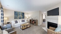This two-story home in Columbus, Ohio offers a thoughtfully organized layout across two floors. The main level features a carpeted living room with a cozy fireplace and flows naturally into a dedicated dining area illuminated by a pendant light. The kitchen is well-equipped with dark cabinetry, granite countertops, stainless steel appliances, and durable wood-look flooring, with a second kitchen area providing added functionality. A convenient in-unit laundry room houses a full-size Whirlpool washer and dryer with overhead wire shelving for storage.

The upper level is home to two bedrooms, including a generously sized primary suite complete with a walk-in closet and an en-suite bathroom featuring a dark vanity with a white countertop. A second bedroom offers comfortable carpet flooring and natural window light. Three bathrooms in total serve the home, including a full bath with a tub-shower combination and neutral tile flooring. Throughout the home, textured ceilings, neutral warm-toned walls, and soft carpet in living and sleeping areas create a cohesive and welcoming ambiance. A hallway and closet complete the practical offerings of this well-rounded two-floor residence.