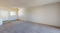 Located at 10201 N 33rd Ave in Phoenix, Arizona, this single-floor, one-bedroom, two-bathroom unit delivers a functional and well-organized layout. The open living area features plush carpeting that transitions to wood-look vinyl flooring near the kitchen and entryway, with a ceiling fan overhead and a sliding glass door that invites natural light and outdoor access. The textured ceilings throughout lend a consistent architectural character across the space.

The kitchen is efficiently designed with white cabinetry, speckled laminate countertops, a stainless steel dishwasher, and a full-size refrigerator, making practical use of the available space. A hallway connects the main living areas to the private bedroom, which is comfortably sized with soft carpeting, a bright window that brings in natural light, and direct access to one of the two bathrooms. This en-suite bathroom features white cabinetry with a wide vanity, a large mirror with overhead lighting, and wood-look flooring. The second bathroom includes a full tub-shower combination with clean white surrounds and matching flooring. Together, these rooms form a cohesive, easy-to-navigate living environment suited for everyday comfort in the heart of Phoenix.
