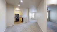 This 630 square foot apartment in Rancho Cucamonga offers a well-designed living space with a focus on functionality and comfort. The single-floor layout comprises one bedroom, one bathroom, and an open-concept kitchen and living area. The primary bedroom, measuring 160 square feet, provides ample space and features plush carpeting and large windows that allow natural light to flood the room.

The modern kitchen is equipped with light-colored cabinetry, black appliances including a refrigerator, stove, and over-the-range microwave, and a practical L-shaped counter layout. The adjoining living area seamlessly integrates with the kitchen, creating a spacious feel ideal for entertaining or relaxing.

The bathroom offers a clean, bright aesthetic with a combined tub and shower, white fixtures, and neutral-toned tile flooring. Throughout the apartment, you'll find neutral wall colors, carpeting in the living areas and bedroom, and wood-look flooring in the kitchen, contributing to a cohesive and contemporary ambiance.

Large windows in the living area and bedroom not only brighten the space but also offer views of the surrounding area. The apartment includes convenient features such as window blinds for privacy and climate control, and a ceiling fan in the bedroom for added comfort. With its efficient use of space and modern amenities, this apartment presents an attractive option for urban living.