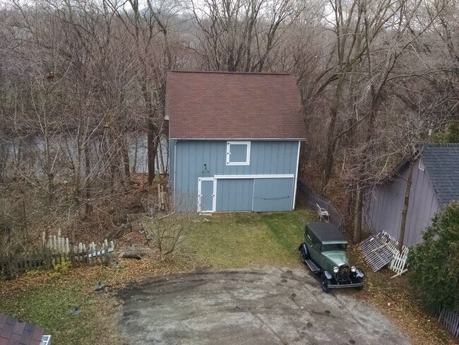 View of the back yard and river as seen from roof of house. - 416 N Huron St