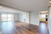 Located at 190 N Shore Rd in Revere, MA, this well-appointed 2-bedroom, 2-bathroom residence offers a thoughtfully designed single-level layout. Hardwood-style flooring flows throughout, complemented by soft neutral wall tones and clean white trim that create a bright, cohesive aesthetic.

The expansive living room is a standout feature, framed by elegant crown molding, stylish track lighting with gold-toned fixtures, and a sliding glass door that opens to a private balcony with open outdoor views. Natural light pours in generously, enhancing the sense of space.

The kitchen is outfitted with white shaker-style cabinetry, light stone countertops, a subway tile backsplash, a stainless steel sink, and a full suite of stainless steel appliances including a range, microwave, and dishwasher.

The generously sized primary bedroom features a walk-in closet and its own access to the balcony, offering additional natural light and views. The second bedroom is well-proportioned with its own closet. Both bathrooms are finished with clean, modern fixtures; one includes a tiled walk-in shower with glass doors and a white vanity. Three closets throughout the unit provide ample storage. Two hallways connect the spaces efficiently, completing this well-organized and move-in-ready home.