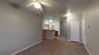 Located at 3015 E Ledbetter Dr in Dallas, Texas, this single-floor residential unit offers a practical and well-organized layout throughout. The living area is generously sized, finished with plush carpeting and equipped with a ceiling fan. Natural light enters through a windowed door, adding brightness to the space. A central kitchen island connects the living area to the kitchen, which features warm honey-toned wood cabinetry, wood-look tile flooring, a double sink, white appliances including a refrigerator and electric range, and ample counter space. A hallway leads to the private bedroom quarters. The bedrooms are carpeted and well-proportioned, each benefiting from natural light through slatted windows. One bedroom includes a walk-in closet with built-in shelving, while another provides direct closet access. The unit includes two full bathrooms: one with a single-sink vanity and tub-shower combo with white tile surround, and a second featuring a double-sink vanity with a warm countertop, a large mirror, and a tub-shower combo. Both bathrooms are finished with wood-look tile flooring. Clean neutral tones are consistent throughout, creating a cohesive and move-in ready environment.