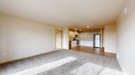 Located at 8120 Evergreen Way in Everett, WA, this well-appointed two-bedroom, two-bathroom residence offers a thoughtfully designed layout across a single floor. The open-concept living and kitchen area creates a welcoming, airy atmosphere, with the kitchen showcasing white shaker-style cabinetry, generous counter space, stainless steel appliances including a range, built-in microwave, dishwasher, and refrigerator, all set atop light hardwood-style flooring with recessed lighting overhead. The adjoining living area transitions to soft, plush carpeting, lending warmth to the space. Large windows and a sliding glass door open to a private balcony, flooding the room with natural light and offering pleasant outdoor views of the surrounding Everett area. Both bedrooms are carpeted and well-proportioned, with the spacious primary bedroom providing ample room for furnishings. A walk-in closet with wire shelving offers practical storage solutions. The two bathrooms are clean and functional, each featuring a full soaking tub and shower combination set on light wood-style flooring. Neutral warm-toned walls throughout the residence create a cohesive, move-in-ready aesthetic suited to a variety of design preferences.