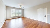 Located at 6354 Township Dr in Roanoke, VA, this 2-bedroom, 2-bathroom residence offers a well-designed single-floor layout with a thoughtful mix of materials and finishes throughout. The combined kitchen and living area forms the heart of the home, where warm hardwood-style flooring flows beneath a ceiling fan and large windows that fill the space with natural light and offer pleasant outdoor views. A door leads directly to a private balcony, extending the living area outdoors.

The kitchen is a standout feature, equipped with rich espresso-toned cabinetry, granite countertops, stainless steel appliances including a refrigerator, range, and microwave, and a peninsula with a double sink — ideal for both cooking and casual dining.

Both bedrooms are carpeted for comfort and fitted with ceiling fans. Each room benefits from generous window placement, providing ample natural light and views of the surrounding greenery. The bedrooms are served by two full bathrooms, each featuring a tub-shower combination with clean white surrounds and tile flooring.

Additional storage is provided by two dedicated closets, and a hallway connects the private and shared spaces efficiently. Neutral warm tones and clean finishes throughout give the residence a bright, move-in-ready character.