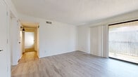 Located at 1935 S Swope Dr in Independence, MO, this single-floor, 2-bedroom, 1-bathroom home offers a clean, modern aesthetic throughout. Light-toned vinyl plank flooring runs through the main living areas, dining room, and secondary bedroom, creating a bright and cohesive feel. The living room is an open, well-lit space featuring a textured ceiling and a built-in closet with bi-fold doors, with a clear sightline connecting to the rest of the home. The dining area flows naturally from the living space, providing a functional layout. The kitchen is outfitted with light gray cabinetry, black hardware accents, light quartz-style countertops, a stainless steel sink with a matte black pull-down faucet, and stainless steel appliances including a refrigerator and dishwasher. Both bedrooms are carpeted and include ceiling fans with overhead lighting. The spacious primary bedroom also features a built-in closet with wire shelving and benefits from natural light through a window. The full bathroom includes a tub-shower combo with tiled surround, light vinyl plank flooring, and a gray vanity with black hardware, maintaining the modern palette found throughout the home.