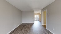 Located at 3201 E Park Row Dr in Arlington, TX, this two-bedroom, two-bathroom residence offers a well-organized single-floor layout designed for comfortable everyday living. The open-concept living and dining area serves as the heart of the home, featuring durable wood-style flooring, neutral gray walls, and a distinctive arched window that fills the space with natural light. A ceiling fan overhead and sliding glass door leading to a private balcony complete the welcoming atmosphere. The kitchen is supported by a dedicated pantry, providing ample storage for an efficient cooking space. A central hallway connects the main living areas to the private quarters, with four closets distributed throughout for generous storage. Both bedrooms are carpeted for comfort and equipped with ceiling fans. The spacious primary bedroom includes a sliding-door closet and dedicated hallway access. The secondary bedroom features an arched window, a walk-in style closet with built-in shelving, and its own ceiling fan. A textured ceiling is consistent throughout the home, adding a classic residential character. With two full bathrooms and a functional layout, this residence balances practicality with everyday comfort in a convenient Arlington location.
