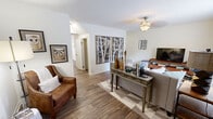 This two-story, two-bedroom, two-bathroom home in Knoxville, Tennessee offers a well-organized layout spread across two floors. The main level features a bright, inviting living room with wood-look flooring, a ceiling fan, and tasteful wall décor. Natural light flows in through large windows, creating a warm and welcoming ambiance. The dining area adjoins the kitchen and is highlighted by elegant French doors that open to the outdoors, adding a sense of openness. The kitchen is well-appointed with warm wood cabinetry, ample counter space, stainless steel appliances, and a window that brings in additional natural light. Upstairs, the generously sized primary bedroom features plush carpeting, a ceiling fan, a large window with outdoor views, and a walk-in closet. The second bedroom is equally spacious, offering dual closets for excellent storage. Both bathrooms are clean and functional, featuring granite-style countertops, large vanity mirrors, and warm wood cabinetry. Hallways on both floors connect the spaces efficiently. Throughout the home, a neutral color palette and consistent flooring choices create a cohesive and comfortable living environment suited for a variety of lifestyles.
