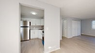 Located at 49 Arborwood Crescent in Rochester, NY, this three-bedroom, two-bathroom home is spread across three thoughtfully laid-out floors, offering a comfortable and functional living environment. The main level features a bright, open living area with light wood-tone flooring that flows seamlessly throughout, creating a cohesive and airy feel. The kitchen is a standout, showcasing crisp white shaker cabinetry, marble-look countertops with a stainless steel undermount sink, and stainless steel appliances, including a full-size refrigerator and range. Natural light filters through window blinds across multiple rooms, casting soft patterns along the neutral grey-toned walls. The generously sized primary bedroom provides ample space and is complemented by two additional bedrooms, each featuring light flooring, windows, and closet storage. The two bathrooms are clean and well-appointed — one includes a full soaking tub with shower, white vanity, and a window for natural ventilation, while the second offers a white vanity with brushed gold hardware accents. The unfinished basement presents a wide-open footprint with painted concrete floors and exposed wood-beam ceilings, offering significant potential for storage or future finishing. Throughout the home, a neutral, modern palette creates a welcoming and move-in-ready atmosphere.