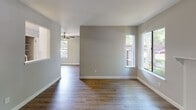Located at 7921 Sunrise Blvd in Citrus Heights, CA, this single-floor apartment offers a well-designed layout with a clean, modern aesthetic. The interior is unified by warm wood-style vinyl flooring and a neutral gray-and-white color palette throughout.

The galley-style kitchen is efficiently organized with white shaker cabinetry lining both walls, providing generous storage above and below. White quartz countertops, a stainless steel sink, and white appliances — including a range, oven, and refrigerator — complete the space.

The living room is a comfortable, open area anchored by a classic white-mantled fireplace and a large window that frames outdoor greenery, filling the room with natural light. An adjacent dining or flex area features a ceiling fan and multiple windows offering additional views of the surrounding landscape.

The bedrooms are bright and airy, each benefiting from natural light through large windows with outdoor views. Closet space is notable, with one bedroom featuring dual closets — an open closet and a separate walk-in — providing ample storage.

The bathroom is clean and straightforward, finished in white with wood-style flooring consistent with the rest of the unit. The overall layout, as seen in the dollhouse view, offers a practical and comfortable flow between all living spaces.