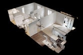 This single-floor residence offers a well-organized layout across a comfortably sized footprint. The living area is bright and open, featuring plush wall-to-wall carpeting, neutral gray walls, and a sliding glass door dressed with vertical blinds that allows abundant natural light and outdoor access. A ceiling fan overhead adds both function and a subtle design element, while wood-look vinyl flooring marks the transition into the kitchen and dining space.

The kitchen is efficiently designed with gray cabinetry, light stone-patterned countertops, stainless steel appliances including a refrigerator, dishwasher, gas range, and microwave, as well as a single-basin sink. Overhead flush lighting keeps the space well-illuminated.

The bedroom is carpeted and generously proportioned, featuring a window with views to the exterior, a closet, and an additional door leading to a walk-through or secondary space. The textured ceiling continues throughout the unit, maintaining a consistent aesthetic.

The bathroom includes a full tub and shower combination with clean white surrounds, brushed nickel fixtures and towel bars, and a standard toilet. The overall ambiance of the unit is clean, neutral, and move-in ready.