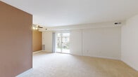 Located at 3601 Gallatin St in Hyattsville, MD, this single-floor, one-bedroom, one-bathroom residence offers a well-organized layout designed for comfortable everyday living. The expansive living room is a standout feature, bathed in natural light streaming through sliding glass doors that open to an outdoor patio, offering views of the surrounding community. A ceiling fan overhead adds to the room's comfort, while soft wall-to-wall carpeting lends warmth throughout. An accent wall provides a touch of color contrast to the otherwise neutral palette.

The generously sized bedroom includes plush carpeting, a ceiling fan with light fixture, a large window for additional natural light, and a spacious closet with bifold doors — providing ample storage. The kitchen is equipped with warm wood cabinetry and granite-style countertops, complemented by marble-look tile flooring that extends into the bathroom. The full bathroom features a white vanity with cabinet storage, a combined shower and bathtub, and clean, bright finishes throughout. A dedicated in-unit laundry area adds everyday convenience. The overall design is clean, functional, and move-in ready.
