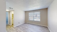 Located at 5000 Harbour Lake Dr. in Goose Creek, South Carolina, this single-floor, two-bedroom, one-bathroom residence offers a functional and well-appointed layout. Throughout the unit, neutral warm-gray tones create a clean, cohesive aesthetic complemented by white trim and textured ceilings.

The living area greets you at the entry with light-toned luxury vinyl plank flooring, a bright window with blinds for natural light, and a ceiling fan with integrated lighting — an ideal comfort feature for the South Carolina climate. This space flows naturally into the kitchen, which is equipped with white cabinetry, stone-look countertops, stainless steel appliances including a refrigerator and dishwasher, and matching LVP flooring.

The spacious primary bedroom features plush carpeting and two side-by-side closets, providing generous storage. The second bedroom also offers LVP flooring and a ceiling fan, making it versatile for use as a guest room or home office. A hallway connects the bedrooms to the shared full bathroom, which includes a tiled tub/shower combo, a white vanity, and wood-look flooring. The single-floor layout and efficient use of space make this unit a practical and comfortable option in the Goose Creek area.