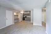Located at 1640 Kendall Dr in San Bernardino, California, this single-floor unit offers a clean, modern aesthetic with consistent wood-look tile flooring throughout. The open-concept living area flows seamlessly into the kitchen, creating a functional and connected layout. A built-in wall shelf adds a practical touch near the entryway, while French doors in the living area invite natural light and provide access to an outdoor space.

The kitchen is well-appointed with grey cabinetry, granite-style countertops, a peninsula breakfast bar, recessed lighting, and black appliances including a gas range and dishwasher. Ample cabinet storage and a double-basin sink make this kitchen both practical and visually cohesive.

The bedrooms feature the same wood-look tile flooring and are generously sized. One bedroom includes a sliding mirrored closet, while another benefits from a corner window allowing natural light to fill the room. The bathroom is outfitted with a grey vanity, granite-style countertop, a large mirror, and a shower-tub combination.

A textured ceiling is consistent throughout the unit, complementing the neutral grey wall tones. The overall ambiance is calm, modern, and move-in ready, offering a well-maintained living environment in a convenient San Bernardino location.