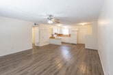 Located at 2500 W 16th St in Plainview, Texas, this single-floor residence offers a practical and well-maintained layout with consistent wood-look flooring carried throughout every room. The open-concept living and dining area is a central feature of the home, offering generous floor space filled with natural light from a front-facing window. A ceiling fan with integrated lighting provides both comfort and illumination, while a textured ceiling adds a classic touch to the overall design.

The kitchen is thoughtfully laid out in a U-shaped configuration, complete with white cabinetry, warm wood-toned countertops, and a matching tile backsplash that adds visual continuity. A white electric range with overhead ventilation, a refrigerator, and a sink with a window view complete the space. A peninsula countertop extends into the living area, providing additional prep or serving space and enhancing the open feel.

The bedrooms are bright and comfortable, each benefiting from natural light through blinds-covered windows and clean neutral walls. The bathroom features a single-vanity with white cabinetry and overhead storage, a toilet, and a full soaking tub with tiled surround, all finished with the same wood-look flooring for cohesion. The home presents a clean, move-in-ready environment well suited for everyday living.
