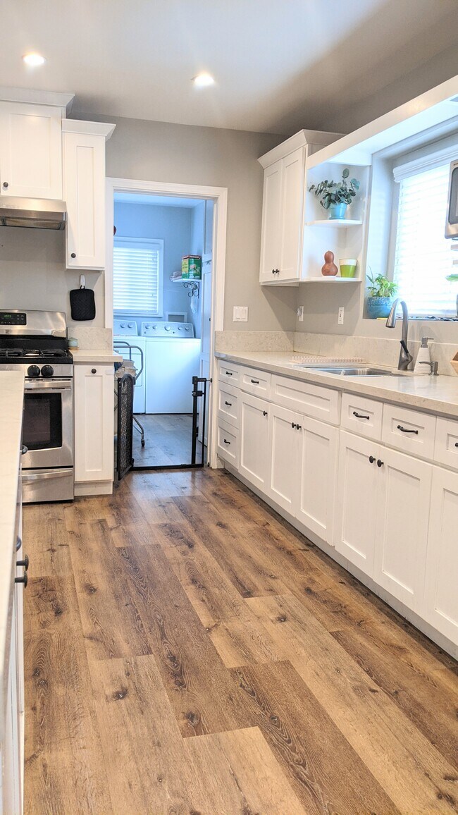Separate laundry room with storage cabinets. Appliances not included - 8184 Madison Ave