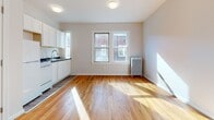 Located at 39 Charter Oak Place in Hartford, Connecticut, this single-floor unit offers a clean, well-maintained living environment with a cohesive design aesthetic. Rich hardwood flooring flows throughout the main living areas and bedrooms, adding warmth and character to the space.

The open living and kitchen area is bright and welcoming, with natural light pouring in through double windows and reflecting off the polished wood floors. The kitchen features white cabinetry, a dark countertop, a stainless steel sink, and white appliances, including a refrigerator and stove, all set against neutral walls. A classic cast-iron radiator provides efficient heating in the main room.

The bedroom areas are generously sized, finished in soft, neutral tones with the same warm hardwood flooring. White panel doors and clean white trim give the rooms a fresh, updated feel, and each space offers practical layout options for furniture placement.

The bathroom is neatly appointed with a full soaking tub and shower combination, a white vanity with a medicine cabinet mirror, and wood-look luxury vinyl flooring, creating a clean and functional environment.

Overall, the space presents a comfortable and practical layout with classic details like hardwood floors and a radiator heating system, complemented by modern, refreshed finishes throughout.