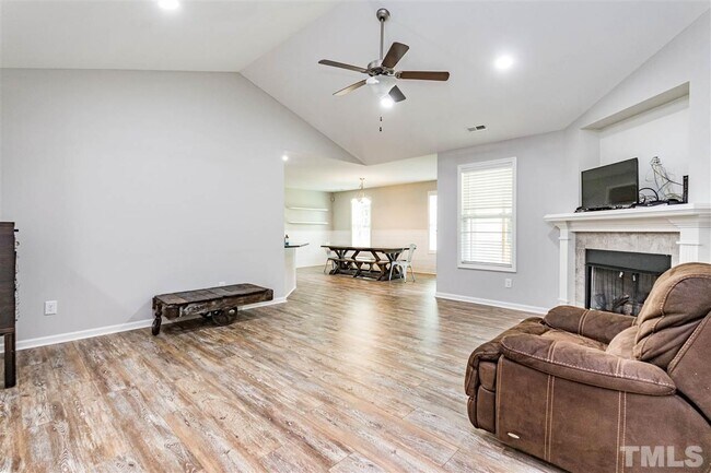 Living room facing dining area. Hallway into bedrooms behind - 90 All Aboard Cir