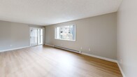 This 1190 square foot single-story residence offers a harmonious blend of comfort and functionality. The home features three bedrooms, including a generous 170 square foot primary bedroom, and two full bathrooms. The open-concept living area combines the kitchen and living room, creating a spacious environment for family gatherings and entertaining.

Light-toned hardwood floors run throughout, complementing the neutral wall colors and providing a bright, airy atmosphere. Large windows in the living areas and bedrooms invite ample natural light and offer views of the surrounding greenery, enhancing the sense of space and connection to the outdoors.

The kitchen is efficiently designed with a galley layout, featuring white cabinetry, contrasting dark countertops, and a full suite of appliances. The bathrooms are outfitted with modern fixtures, including a shower-tub combination with white tiled surrounds.

The property's single-floor layout ensures easy accessibility and flow between rooms. A central hallway connects the living spaces to the private areas, maintaining a clear separation between communal and personal spaces. The textured ceiling throughout adds a subtle architectural detail to the overall design.

Located at 4601 E 18th St in Vancouver, WA, this home offers a comfortable living space in a residential setting, ideal for those seeking a well-appointed, low-maintenance property with modern amenities.