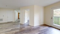 Located at 801 S German Ln in Conway, Arkansas, this single-story 2-bedroom, 1-bathroom home offers a well-designed layout with a clean, modern aesthetic. Light-toned wood-look flooring runs throughout the entire home, creating a cohesive and airy feel. The heart of the home is an open-concept living, dining, and kitchen area that flows seamlessly together. The kitchen is well-appointed with white shaker-style cabinetry, granite-look countertops, a peninsula with a sink, and white appliances including a range and refrigerator — all complemented by abundant cabinet storage. The living area features a ceiling fan and access to a private outdoor space through French doors that flood the room with natural light and offer pleasant outdoor views. The primary bedroom is a comfortable size with a ceiling fan and a large window bringing in natural light. The second bedroom is equally well-lit and offers access to closet storage. The full bathroom is neatly finished with a granite-topped vanity, a full tub-and-shower combination, and wood-look flooring. Additional practical spaces include a dedicated laundry area, a utility room, and multiple closets for ample storage throughout the home.