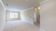 Located at 201 Sandbar Cir in Greensboro, NC, this single-floor, 2-bedroom, 3-bathroom home offers a well-organized layout with a thoughtful blend of comfort and functionality. The living area features soft carpeting, warm neutral tones, crown molding, and a large window that allows natural light to fill the space, creating a bright and welcoming atmosphere.

The kitchen is designed with rich dark wood cabinetry, a raised breakfast bar with light granite-style countertops, and tile flooring, opening conveniently toward the main living and dining areas. The layout transitions smoothly between spaces, lending an open and connected feel throughout.

The spacious primary bedroom offers generous proportions with plush carpet, a ceiling fan, and a window with natural views. The second bedroom, also carpeted and naturally lit, provides a comfortable and versatile space. Three full bathrooms serve the home, each finished with tile flooring and vanities with wood cabinetry.

A dedicated laundry room with wire shelving and tile flooring adds practical convenience. A separate closet provides additional storage. Throughout the home, consistent warm beige walls, clean white trim, and cohesive finishes create a unified and move-in-ready aesthetic suited for everyday living.