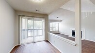 Located at 2208 Yager Creek Dr in Charlotte, NC, this 2-bedroom, 1-bathroom single-floor home offers a well-designed layout with comfortable, practical living spaces. The living room is a standout feature, boasting rich hardwood-style flooring, a tiled fireplace, and a sliding glass door with vertical blinds that opens to a private outdoor area, allowing generous natural light to fill the room. A second window adds additional brightness, enhancing the open feel of the space.

The kitchen is positioned adjacent to the living area and is equipped with white cabinetry and stainless steel appliances, providing a clean and functional cooking environment. A dedicated laundry area with a full-size washer and dryer adds everyday convenience.

Both bedrooms are carpeted and finished in neutral tones, offering a quiet and comfortable retreat. The primary bedroom includes a spacious walk-in closet with wire shelving for ample storage. Windows in each bedroom provide outdoor views and natural light. The bathroom features a full tub/shower combination with hardwood-style flooring and a white vanity.

Throughout the home, textured ceilings, neutral wall tones, and consistent finishes contribute to a cohesive and inviting ambiance.