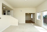 Located at 2400 Skyline Blvd in the coastal city of Pacifica, California, this single-floor residence offers a clean, well-maintained interior with a practical and comfortable layout. The entryway features rich hardwood flooring and a pendant light fixture, setting a welcoming tone as you step inside. The living area transitions seamlessly into the space, finished with neutral-toned carpet that runs throughout the bedrooms and common areas, creating a cohesive, comfortable feel.

The kitchen is a standout feature, outfitted with warm honey-toned wood cabinetry, light quartz countertops, and a full suite of stainless steel appliances including a range, microwave, dishwasher, and refrigerator. Recessed lighting and light wood-style flooring complete the space, making it both functional and visually inviting.

The bedrooms are generously proportioned, each featuring plush carpet, neutral walls, and windows that bring in natural light. At least one bedroom includes a built-in closet with a hanging rod, providing practical storage. The bathrooms are tastefully updated, with one featuring a tub-shower combo, wood-toned vanity cabinetry, and quartz countertops, while a second offers a clean, minimalist design with a round mirror and brushed nickel fixtures throughout.