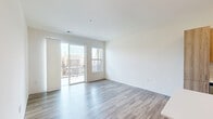 Located at 4733 S Packard Ave in Cudahy, Wisconsin, this well-designed 2-bedroom, 2-bathroom unit offers a thoughtful layout across a single floor. The open-concept kitchen and living area serves as the heart of the home, anchored by light hardwood-style flooring that flows throughout. The kitchen is outfitted with warm wood-tone cabinetry extending to the ceiling, white quartz countertops, a classic subway tile backsplash, and a full suite of stainless steel Whirlpool appliances including a French door refrigerator, electric range, built-in microwave, and dishwasher. A peninsula provides additional prep and dining space. The living area is bright and airy, enhanced by a sliding glass door that opens to a private balcony, allowing ample natural light to fill the space. Both bedrooms feature plush carpeting and windows that bring in natural light. The generously sized primary bedroom includes a closet and direct access to its own bathroom, which is appointed with a glass-enclosed shower, wood-tone vanity with white countertop, and hardwood-style flooring. The second bathroom features a soaking tub and shower combination with built-in shelving. The unit also includes a dedicated closet for additional storage.
