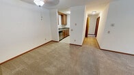 Located at 7726 Radcliffe Drive in Madison, WI, this 2-bedroom, 1-bathroom apartment offers a well-organized single-floor layout. The open living area is carpeted and filled with natural light, featuring a sliding glass door that provides direct access to the outdoors and a baseboard heating system throughout. A ceiling fan adds to the comfort of the living space, which flows seamlessly into the galley-style kitchen. The kitchen is well-appointed with warm wood cabinetry, dark granite countertops, tile flooring, a stainless steel refrigerator, electric range, built-in microwave, and a dishwasher — providing ample storage and functionality. Both bedrooms are carpeted and feature windows with outdoor views and baseboard heaters. The primary bedroom includes a closet with a hanging rod, while warm wood-trimmed doors and red-oak baseboards carry a consistent aesthetic throughout the unit. The full bathroom features tile flooring, a granite-topped vanity with a framed mirror, and a tub-shower combination. A dedicated closet adds additional storage. The unit's neutral palette and cohesive finishes create a clean, functional living environment well-suited for everyday comfort.
