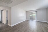 Located at 1580 Shadowridge Drive in Vista, CA, this single-story, 2-bedroom, 1-bathroom home offers a practical and well-organized layout across a comfortable footprint. The living room features wood-look laminate flooring, neutral warm-toned walls, and a textured ceiling, with a sliding glass door that opens to a private patio and allows natural light to fill the space. The open flow connects the living area to a dedicated dining space and kitchen. The kitchen is well-appointed with rich wood cabinetry, granite-style countertops, and a full suite of black appliances including a refrigerator, range, built-in microwave, and dishwasher, all set over light hardwood-style flooring. Both bedrooms are generously sized with wood-look flooring, neutral paint, textured ceilings, and closets with sliding doors — one featuring mirrored panels. The shared bathroom includes a wood-tone vanity with a white countertop, a tub-shower combination, and light flooring. Additional highlights include four closets for ample storage, an in-unit laundry area, and a hallway connecting the main spaces. The home offers a clean, move-in ready aesthetic throughout.