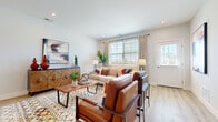 Located at 4522 Hickory Chase Way in Hilliard, Ohio, this thoughtfully designed 2-bedroom, 2-bathroom single-floor home offers a comfortable and modern living experience. The open-concept layout seamlessly connects the living room and kitchen, creating an inviting, airy atmosphere filled with natural light from large windows. The living area features light-toned hardwood-style flooring, recessed lighting, and generous space for relaxing and entertaining. The kitchen is a standout, showcasing white shaker cabinetry, stainless steel appliances, a decorative tile backsplash, and a large island with bar seating — ideal for casual dining or hosting. The spacious primary bedroom is carpeted for comfort and includes a well-sized walk-in closet with built-in shelving. The primary bathroom offers a clean, contemporary design with white cabinetry, a quartz countertop, and a glass-enclosed shower. The second bedroom is equally versatile, featuring plush carpet and a closet, while the second bathroom includes a full tub-shower combination and matching white vanity. Two hallways provide smooth circulation throughout the home. Clean white walls, consistent flooring choices, and modern fixtures give the entire space a cohesive, polished feel.