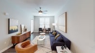 Located at 290 W Front St in Mishawaka, Indiana, this single-floor residence showcases a contemporary design with a cohesive, modern aesthetic throughout. The open-concept layout connects the living, dining, and kitchen areas seamlessly, with dark hardwood-style flooring anchoring the shared spaces.

The kitchen is a standout feature, equipped with white shaker cabinetry extending to the ceiling, granite countertops, a classic subway tile backsplash, and stainless steel appliances. A central island with matching granite provides additional workspace and casual seating, while pendant lighting adds a polished finish overhead.

The living area offers generous proportions, neutral-toned walls, and large windows that invite natural light. A ceiling fan and room for both a sitting and dining arrangement make it a versatile, comfortable space.

The bedrooms are carpeted for warmth and comfort. One bedroom features a large sliding glass door with vertical blinds, allowing outdoor views and natural light, while both rooms include ceiling fans. The bathroom is fitted with a dual-sink vanity topped with granite, white cabinetry, black-framed mirrors, and wood-style flooring, delivering a clean, refined look throughout.