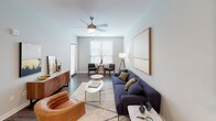 Located at 290 W Front St in Mishawaka, Indiana, this single-floor residence showcases a contemporary design with a cohesive, modern aesthetic throughout. The open-concept layout connects the living, dining, and kitchen areas seamlessly, with dark hardwood-style flooring anchoring the shared spaces.

The kitchen is a standout feature, equipped with white shaker cabinetry extending to the ceiling, granite countertops, a classic subway tile backsplash, and stainless steel appliances. A central island with matching granite provides additional workspace and casual seating, while pendant lighting adds a polished finish overhead.

The living area offers generous proportions, neutral-toned walls, and large windows that invite natural light. A ceiling fan and room for both a sitting and dining arrangement make it a versatile, comfortable space.

The bedrooms are carpeted for warmth and comfort. One bedroom features a large sliding glass door with vertical blinds, allowing outdoor views and natural light, while both rooms include ceiling fans. The bathroom is fitted with a dual-sink vanity topped with granite, white cabinetry, black-framed mirrors, and wood-style flooring, delivering a clean, refined look throughout.