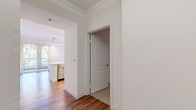 Located in the Playa Vista neighborhood of Los Angeles, this thoughtfully designed 3-bedroom, 2-bathroom residence offers a comfortable and functional single-floor layout. Warm hardwood flooring flows throughout the main living areas, complemented by crisp white walls and crown molding details that lend a clean, polished aesthetic.

The kitchen is a standout feature, outfitted with stainless steel appliances including a gas range, microwave, and full-size refrigerator. Light wood cabinetry and a quartz countertop with a deep undermount sink complete the modern, functional space.

Both bathrooms are finished with large-format dark stone-look tile on the floors and walls, each featuring a soaking tub with overhead shower, a light wood vanity, and built-in shelving for added storage convenience.

The three bedrooms offer plush carpeting and natural light from exterior-facing windows. The primary bedroom is generously sized and includes access to a well-organized walk-in closet with built-in shelving and hanging rods. A second walk-in closet provides additional storage capacity.

A welcoming entrance leads into a central hallway that connects all areas of the home, ensuring a logical and efficient flow throughout. The overall ambiance is clean, bright, and move-in ready.