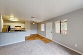 Located at 591 Peabody Rd in Vacaville, CA, this single-floor, one-bedroom, one-bathroom unit offers a thoughtfully organized layout with a clean, modern aesthetic throughout. The open-concept main area seamlessly connects the kitchen, dining, and living spaces, creating an efficient and versatile environment. The kitchen is equipped with stainless steel appliances, including a refrigerator and range, white cabinetry, a dark countertop peninsula with an integrated sink, and warm hardwood-style flooring that extends through the common areas. A ceiling fan overhead adds to the comfort of the living space, which transitions into soft carpeting and features a front entry door flanked by windows with vertical blinds, allowing natural light to filter in. The bedroom offers a comfortable, carpeted retreat with a window providing natural light and outdoor views, as well as a dedicated closet for storage. The bathroom is finished with a white vanity featuring a granite-style countertop, a tub/shower combination, and matching hardwood-style flooring, maintaining a cohesive look throughout. Neutral gray walls and white trim are consistent across all rooms, lending the space a clean, contemporary feel.