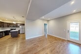 Located at 485 S 44th St W in Billings, Montana, this well-appointed 2-bedroom, 2-bathroom single-floor home offers a thoughtfully designed layout with modern finishes throughout. The open-concept living, dining, and kitchen area serves as the heart of the home, featuring warm hardwood-style flooring and a neutral color palette that creates a bright, welcoming atmosphere. The kitchen is equipped with stainless steel appliances — including a refrigerator, range, and over-the-range microwave — complemented by rich dark cabinetry, white quartz countertops, a subway tile backsplash, a center island, and stylish pendant lighting overhead. Both bedrooms are carpeted for comfort and include windows that allow natural light and views of the surrounding neighborhood. The primary bedroom connects to a well-organized walk-in closet with built-in shelving. The two bathrooms are finished consistently with dark vanity cabinetry, white countertops, and hardwood-style flooring; one features a shower-tub combination. Additional highlights include three total closets, an in-unit laundry area, and a utility room, providing ample storage and everyday convenience throughout the home.
