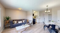 Located at 2353 Portland St in Los Angeles, CA, this efficient one-bedroom, one-bathroom unit offers a well-designed layout that maximizes every square foot of its single-floor footprint. Light wood-tone flooring runs throughout, creating a cohesive and airy feel across all rooms.

The open-concept living and dining area serves as the heart of the unit. The living space features a large window with vertical blinds, allowing natural light to fill the room, and includes a wall-mounted AC unit. The dining area is anchored by a stylish chandelier overhead, with a wall-mounted TV and easy access to the kitchen. The kitchen is outfitted with white shaker-style cabinetry, a black gas range, black refrigerator, and a clean white countertop with an undermount sink.

The spacious bedroom comfortably accommodates multiple beds and desks, making it versatile for various living arrangements. It features a ceiling fan, a wide window with views to the outside, and direct access to a walk-in closet lined with built-in shelving on three sides.

The bathroom is finished in a clean, modern aesthetic with a white vanity, quartz countertop, matte black faucet, and a mirrored medicine cabinet. Natural light from a high window brightens the space, completing this well-appointed Los Angeles unit.