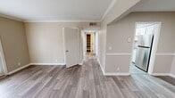 Located at 1505 Greenbrier Ridge Way in Knoxville, TN, this single-story, 1-bedroom, 2-bathroom home offers a well-designed layout with thoughtful finishes throughout. Wood-look plank flooring runs through the main living areas, complemented by neutral warm-beige walls and crisp white trim with crown molding details visible in the living room and hallway.

The living room is bright and welcoming, featuring crown molding and a front entry door alongside a glass-paneled door that floods the space with natural light and provides outdoor access. The adjacent dining area connects seamlessly to the galley-style kitchen, which is a standout feature of the home. The kitchen is equipped with white shaker cabinetry, granite countertops, stainless steel appliances, and a skylight overhead that enhances natural illumination.

The spacious bedroom is carpeted for comfort, includes a ceiling fan with lighting, and features two windows that offer outdoor views and ample natural light. Both bathrooms are finished with granite-topped vanities, white cabinetry, and tiled tub-shower combinations. A dedicated closet provides organized storage, and a connecting hallway ties all rooms together efficiently. This home presents a clean, modern aesthetic throughout.