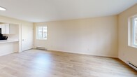 Located at 14 Darby Ct in New Hartford, NY, this single-floor, two-bedroom, two-bathroom residence offers a well-organized and functional layout. The open-concept living and kitchen area sets a welcoming tone, with light hardwood-style flooring that flows throughout the main living spaces and bright, neutral warm-beige walls that lend a clean, airy feel. Natural light filters in through multiple windows, enhancing the sense of openness.

The kitchen is outfitted with crisp white cabinetry, a peninsula countertop in white with an undermount sink, and black stainless appliances including a refrigerator, range, and over-the-range microwave. The peninsula opens directly to the living area, making it ideal for everyday functionality.

Both bedrooms are well-proportioned, with the primary bedroom offering a comfortable footprint and plush carpeted flooring. The second bedroom also features light hardwood-style flooring and a large window with views of the surrounding neighborhood. Both bathrooms are finished with wood-look flooring, and one includes a full soaking tub and shower combination with chrome fixtures.

A dedicated laundry area with washer/dryer hookups adds in-unit convenience, and baseboard heating is present throughout. This residence combines practicality with a clean, modern aesthetic.