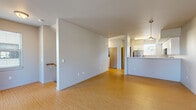 Located at 2850 Shadow View Dr in Eugene, Oregon, this two-bedroom, one-bathroom multi-story home is thoughtfully laid out across three floors. The main living level is the heart of the home, featuring warm bamboo-style hardwood flooring that flows seamlessly through an open-concept living area into a kitchen defined by a raised breakfast bar, pendant lighting, white cabinetry, and stainless steel appliances. Clean lines, neutral gray walls, and an uncluttered layout give the main floor a bright, modern feel. An entry-level ground floor provides a welcoming foyer with a frosted-glass door and additional flooring that matches the main level. Carpeted staircases with wood handrails connect each floor, adding warmth and practicality to the vertical circulation. The upper floor houses the bedrooms, including a generously sized primary bedroom with tall ceilings, a large window offering neighborhood views, and direct access to the full bathroom. The bathroom features dark wood cabinetry, a dual-sink vanity with white countertops, tile flooring, and a window that allows natural light. The secondary bedroom offers comfortable carpet, a closet with a light wood door, and a bright, neutral palette throughout. The hallway on the upper level includes closet storage with rod fixtures. Overall, the home presents a clean, contemporary aesthetic well-suited for modern living.