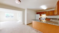 Located at 245 Main St in Toms River, NJ, this 2-bedroom, 2-bathroom residence offers a thoughtfully laid-out single-floor floor plan with a comfortable and functional design. The open-concept kitchen is a standout feature, showcasing warm honey-toned wood cabinetry, granite countertops, and a peninsula that flows seamlessly into the dining and living areas. The kitchen is equipped with white appliances including a range, refrigerator, and dishwasher, and is finished with attractive stone-tile flooring. Soft, neutral carpet extends throughout the living spaces and bedrooms, contributing to a warm, inviting ambiance. The bedrooms are bright and airy, benefiting from large windows that invite natural light and offer views of the surrounding area. The generously sized primary bedroom includes a dedicated closet with built-in shelving. Additional storage is well-covered, with five closets distributed throughout the unit. Both bathrooms feature wood-toned vanities with solid countertops; one includes a full tub/shower combination. A dedicated laundry area adds everyday convenience. The hallway connects all spaces efficiently, creating a cohesive and easy-to-navigate layout throughout this well-appointed Toms River residence.