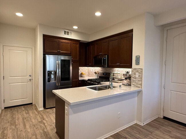 Modern kitchen with quartz counters & stainless appliances - 5020 Verdugo Way