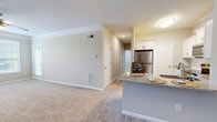 Located at 950 E Main St in Cartersville, Georgia, this single-floor, 3-bedroom, 2-bathroom residence offers a thoughtfully designed layout with a comfortable and functional flow. The entrance opens into a hallway that leads to a combined dining, kitchen, and living area — the heart of the home. The kitchen is well-equipped with stainless steel appliances, white shaker-style cabinetry, a subway tile backsplash, granite countertops, and a peninsula island ideal for casual dining or meal prep. Wood-style flooring anchors the kitchen and entry areas, while plush carpeting extends throughout the living room and bedrooms.

The living room features crown molding, a ceiling fan, and a door with a window that allows natural light to fill the space. The spacious primary bedroom includes a ceiling fan and direct access to its own bathroom and a generous walk-in closet with wire shelving. The two additional bedrooms are bright and comfortable, each with ceiling fans and ample natural light from large windows. Both bathrooms are finished with granite-topped white vanities, large mirrors, and wood-style flooring. A dedicated laundry room and utility room add everyday convenience, while seven closets throughout ensure exceptional storage capacity.