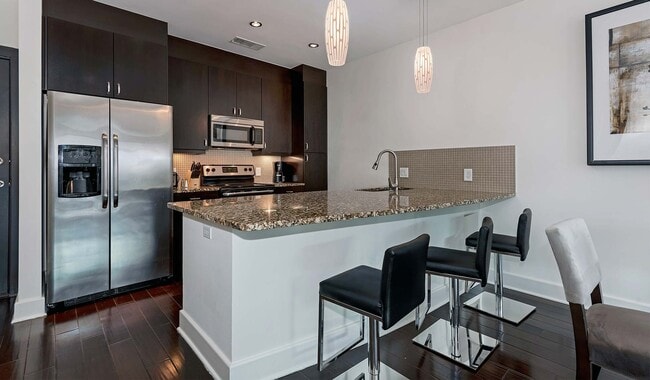 Upgraded kitchens with granite countertops and stainless steel appliances - 1045 On The Park Apartment Homes