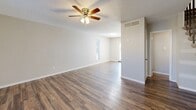 Located at 2001 Slayden St in Brownwood, Texas, this two-story home offers a practical and comfortable layout spread evenly across two floors. The main level features durable hardwood-style flooring throughout the open living area, which is equipped with a ceiling fan and light fixture. Natural light filters in through windows near the entryway, creating a welcoming atmosphere. The kitchen is well-appointed with warm wood cabinetry, tile-accented countertops, a double-basin sink, and white appliances including a refrigerator, dishwasher, and range. A dedicated laundry area with shelving is conveniently located adjacent to the kitchen. A full bathroom on the main level includes a wood-toned vanity with a stone-look countertop and a bathtub. The second floor hosts both bedrooms, each finished with plush carpet and ceiling fans. The spacious primary bedroom offers generous room to furnish, while the secondary bedroom features a large window that allows natural light to brighten the space. Both bedrooms are served by multiple closets, with six closets total throughout the home. A second full bathroom is also located upstairs. The home additionally includes a private patio, providing outdoor space for relaxation.