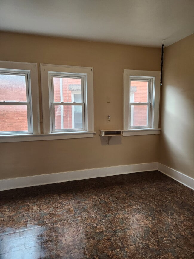 A large kitchen with lots of natural light. - 446 W 7th St